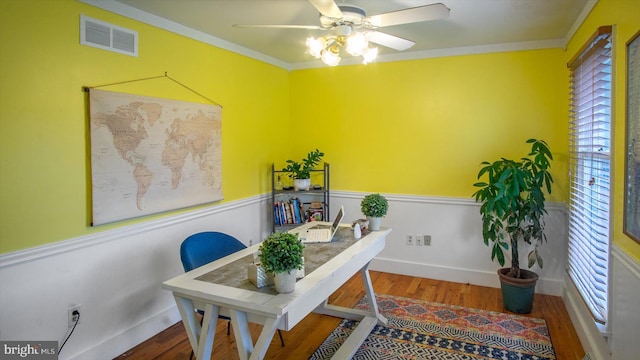 office space featuring ceiling fan, ornamental molding, and wood-type flooring