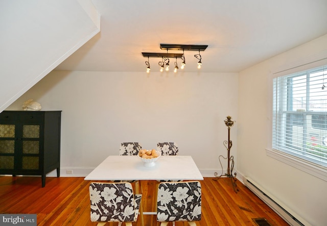 dining room featuring dark hardwood / wood-style flooring and baseboard heating