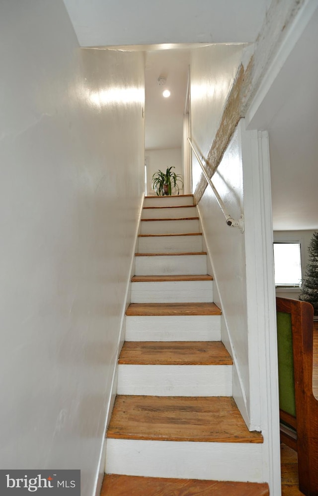 stairs with hardwood / wood-style floors