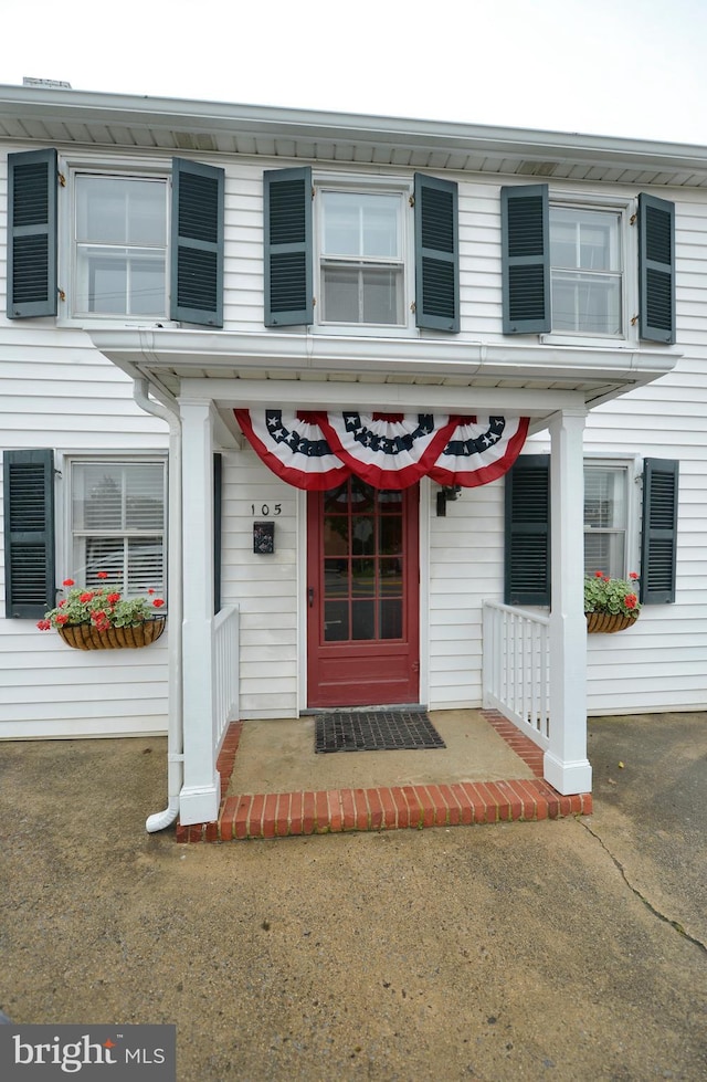 view of exterior entry featuring a porch