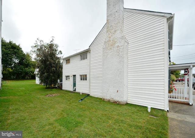 view of side of home with a lawn