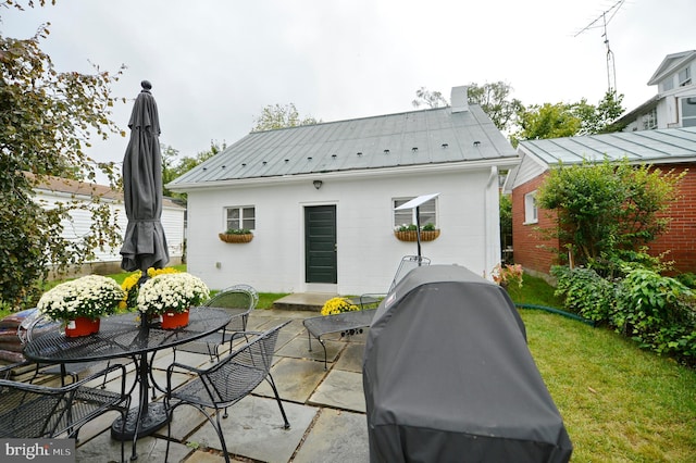 rear view of house featuring a patio and a yard