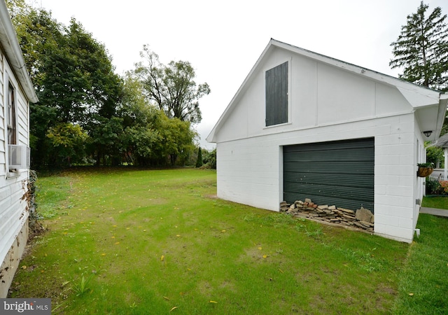 garage featuring cooling unit and a lawn