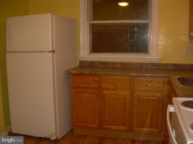 kitchen with white appliances and wood-type flooring