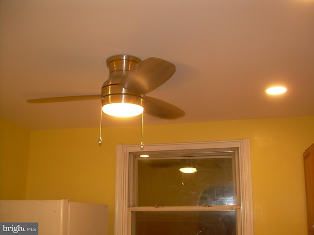 room details with ceiling fan and refrigerator