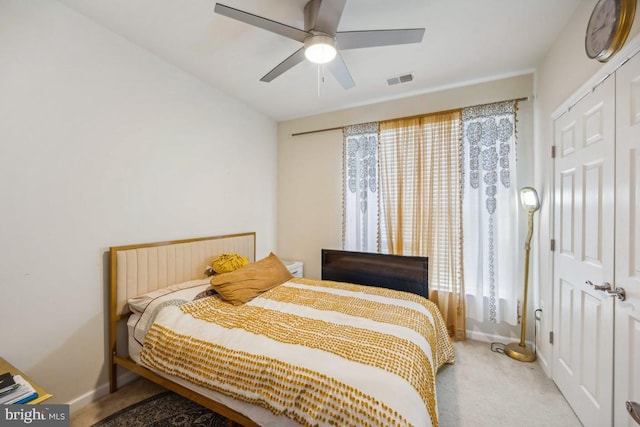 bedroom with ceiling fan, a closet, carpet flooring, and multiple windows