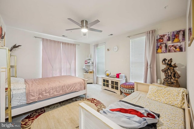 bedroom featuring ceiling fan and carpet