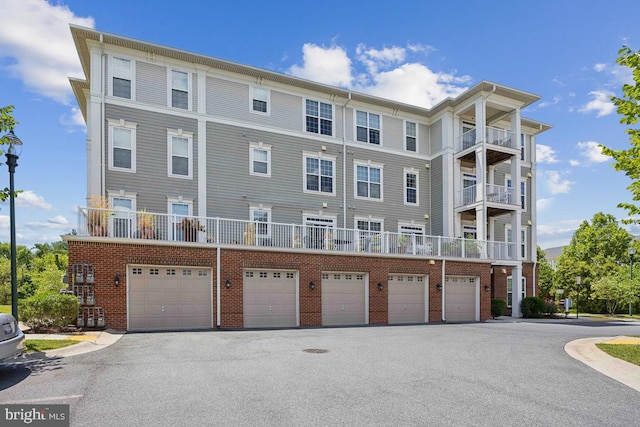 view of front of property with a balcony and a garage