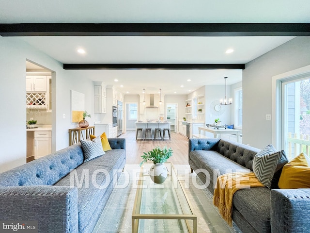 living room featuring an inviting chandelier and light wood-type flooring