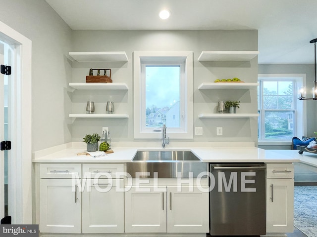 bar with pendant lighting, white cabinetry, stainless steel dishwasher, and sink