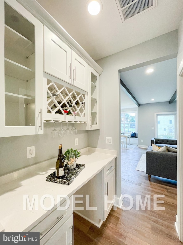 kitchen featuring white cabinets and light wood-type flooring