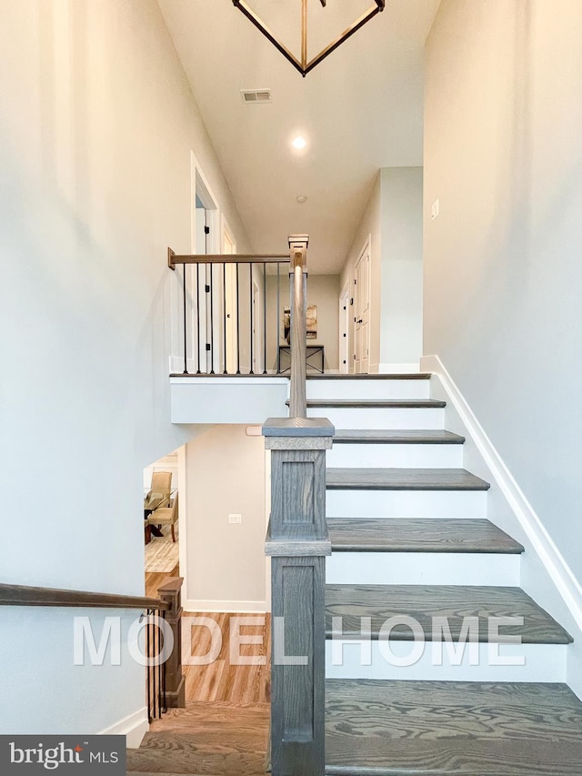 staircase featuring hardwood / wood-style floors