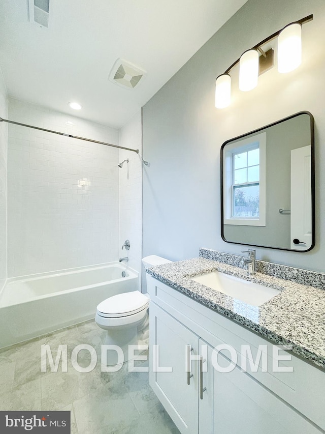 full bathroom with vanity, tiled shower / bath combo, and toilet