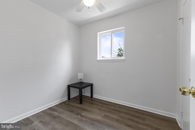 empty room with ceiling fan and dark hardwood / wood-style floors