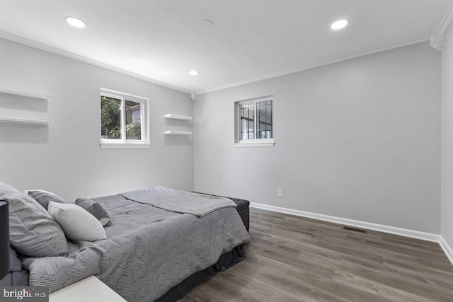 bedroom with crown molding and dark wood-type flooring