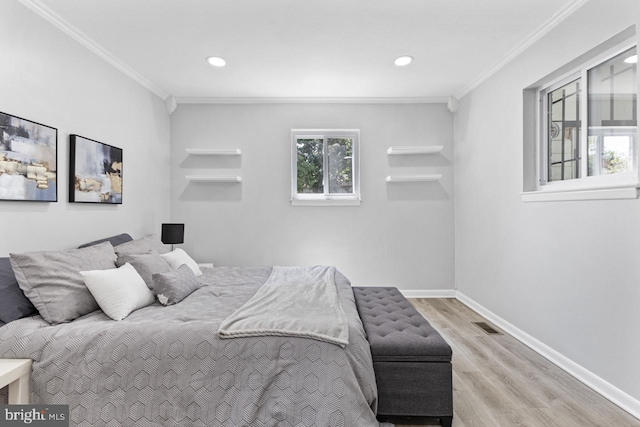 bedroom featuring crown molding and light hardwood / wood-style flooring