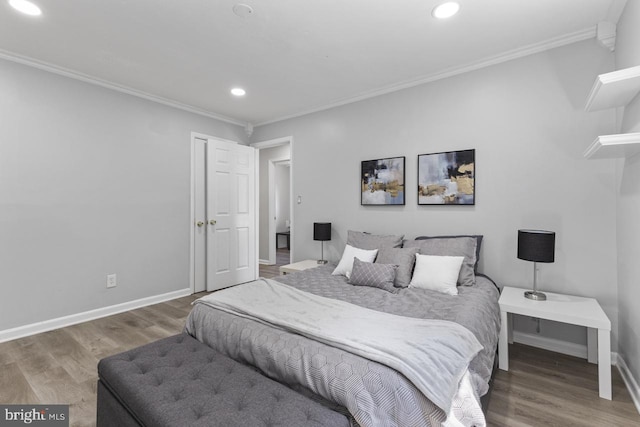 bedroom featuring ornamental molding and hardwood / wood-style flooring