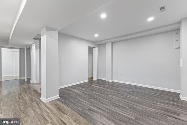 basement with dark hardwood / wood-style flooring