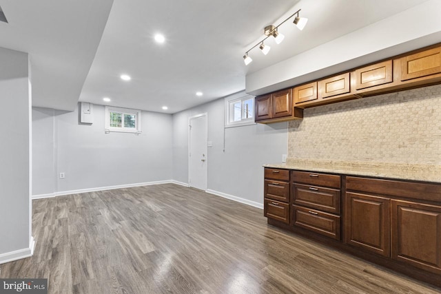 basement with dark hardwood / wood-style flooring