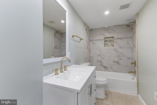 full bathroom featuring tile patterned floors, toilet, tiled shower / bath combo, and vanity