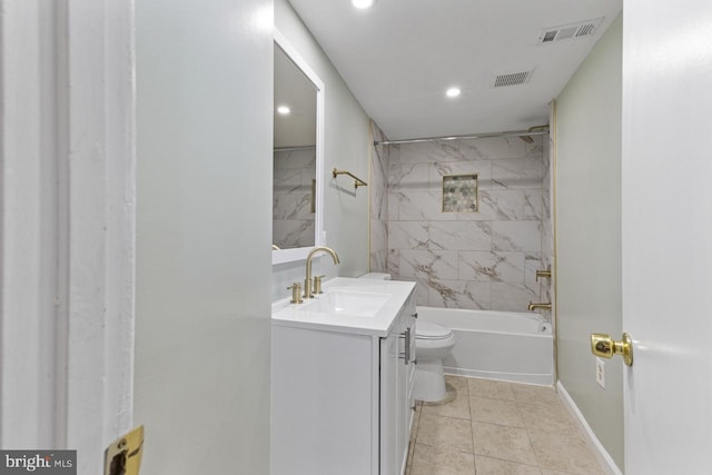 full bathroom featuring tiled shower / bath combo, vanity, toilet, and tile patterned floors