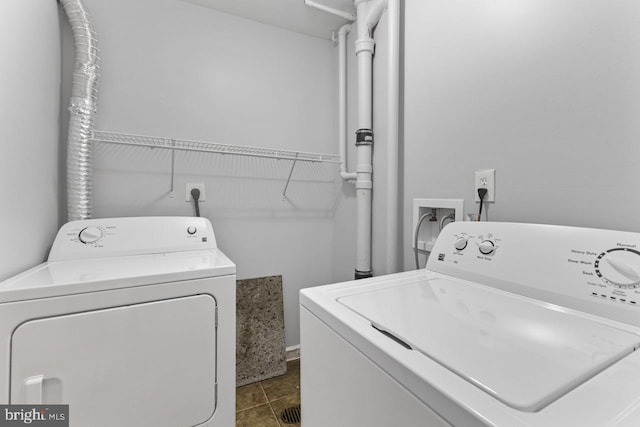 laundry area with washing machine and dryer and tile patterned floors