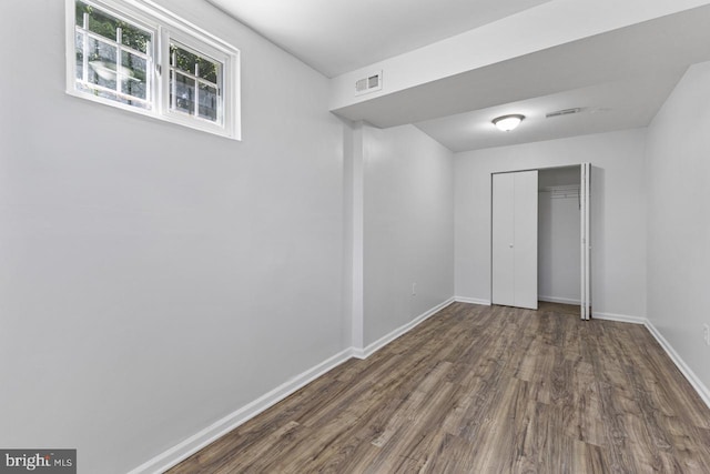 empty room with dark wood-type flooring