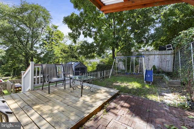 deck with a storage shed and a patio area