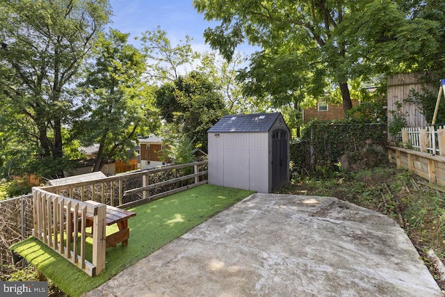 view of yard with a storage shed and a patio