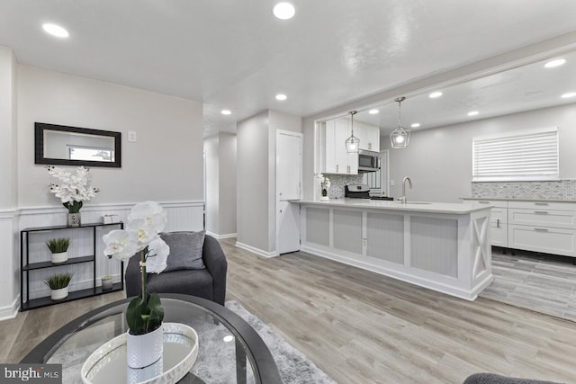 interior space with light wood-type flooring and sink