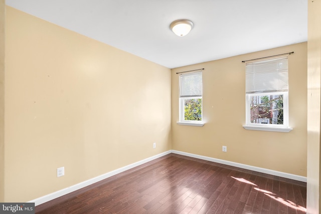 spare room featuring dark hardwood / wood-style flooring