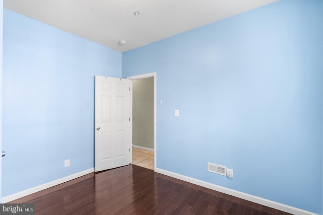 spare room with hardwood / wood-style flooring