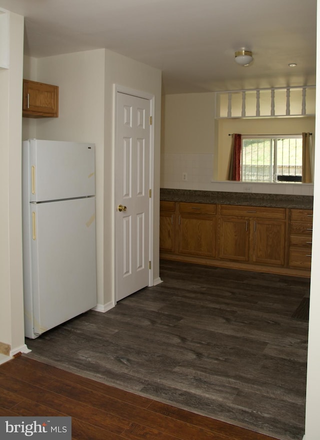 kitchen with dark wood-type flooring and white fridge