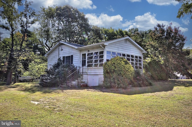 view of side of home featuring a yard