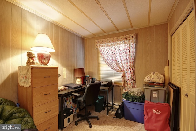 office area featuring light carpet, crown molding, a textured ceiling, and wood walls