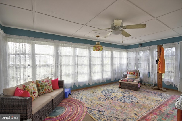 sunroom featuring a paneled ceiling and ceiling fan