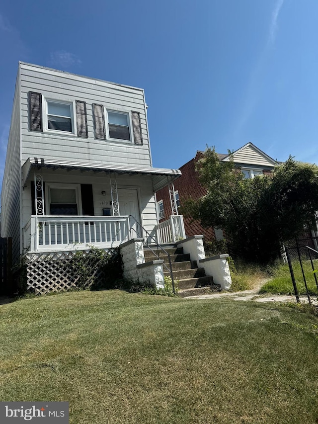 view of front of property with a front lawn and covered porch