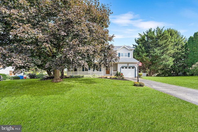 obstructed view of property with a garage and a front lawn