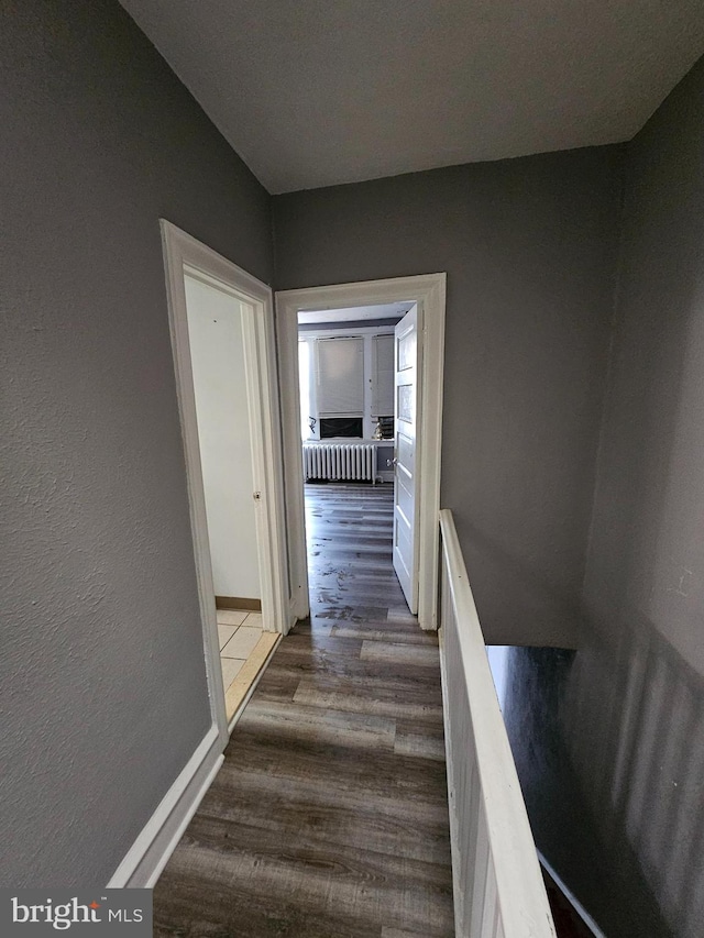 corridor featuring dark hardwood / wood-style floors