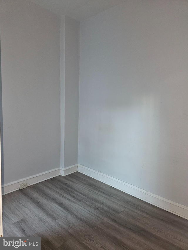 spare room with dark wood-type flooring