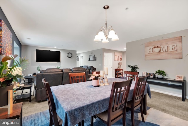 carpeted dining space featuring a chandelier