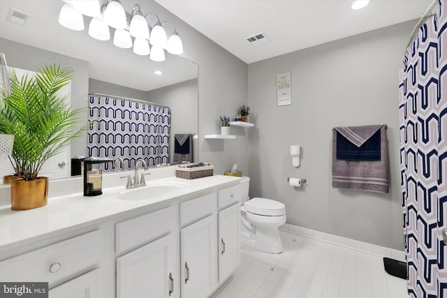 bathroom featuring vanity, toilet, and tile patterned floors