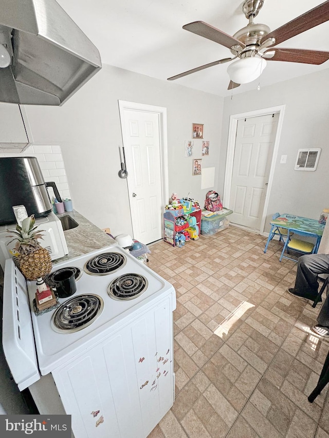 kitchen with ceiling fan, exhaust hood, white electric range oven, and white cabinets