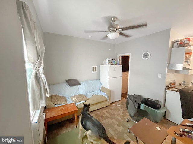 interior space featuring ceiling fan and white fridge