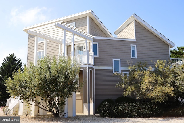 view of side of home featuring a pergola and a balcony