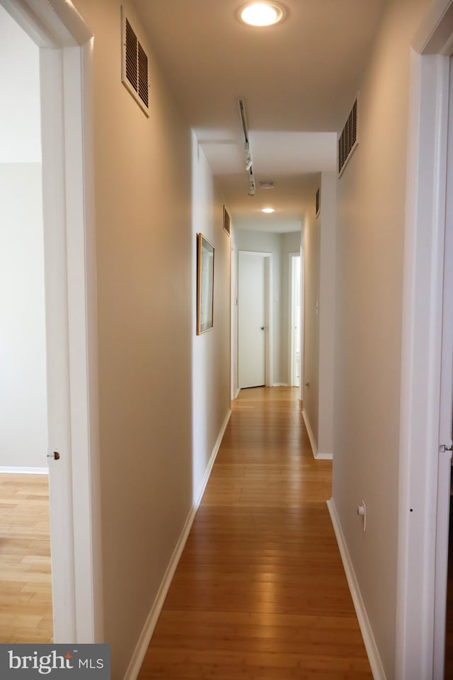 corridor featuring hardwood / wood-style flooring