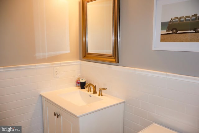 bathroom featuring tile walls and vanity