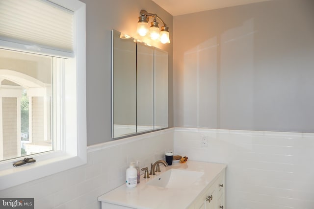 bathroom featuring tile walls and vanity