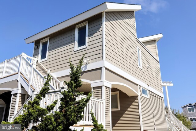 rear view of property featuring a balcony, a patio, and a fenced in pool