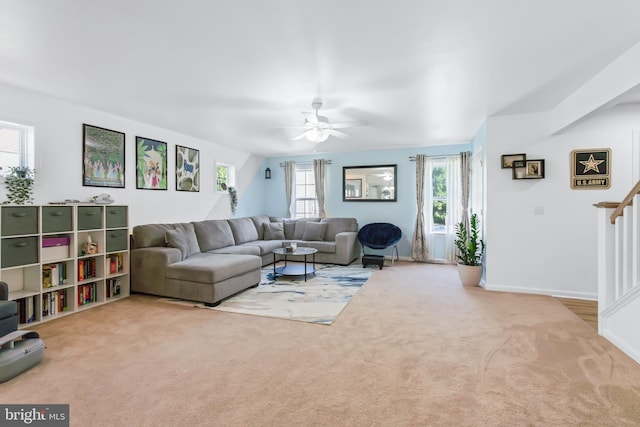 carpeted living room with ceiling fan and a healthy amount of sunlight